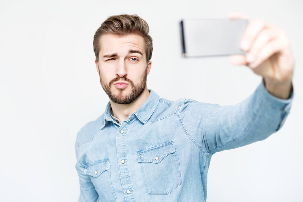 A narcissist taking a selfie of himself.