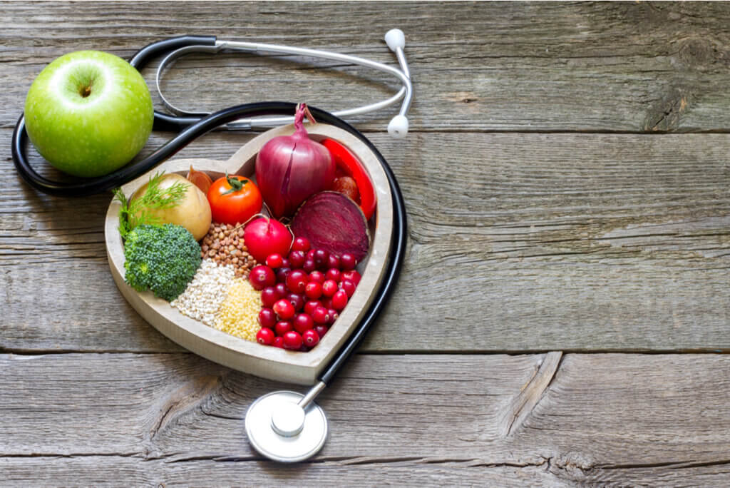 A stethoscope sitting by a heart-shaped bowl with antioxidant sources