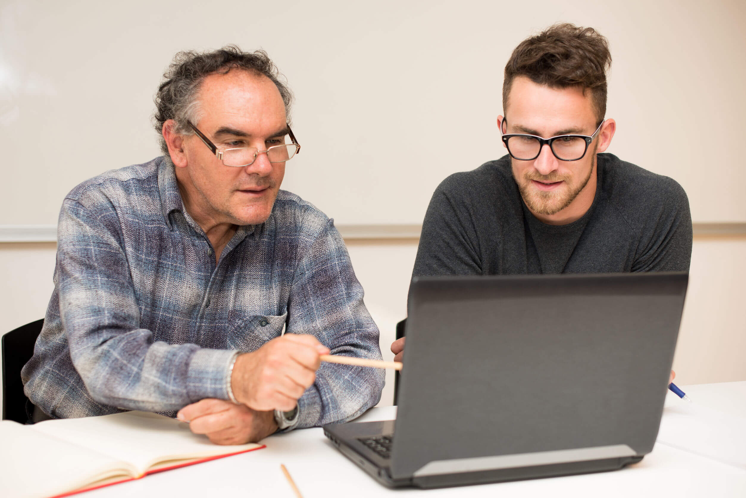 Researchers looking at a laptop computer.