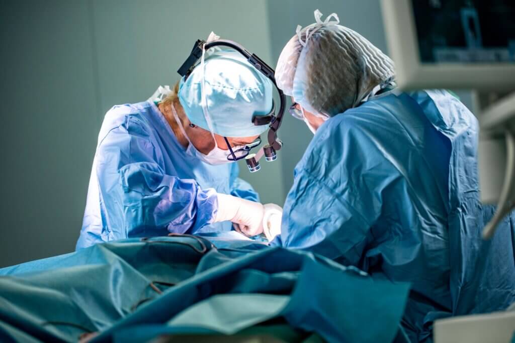 Doctors operating on a person.