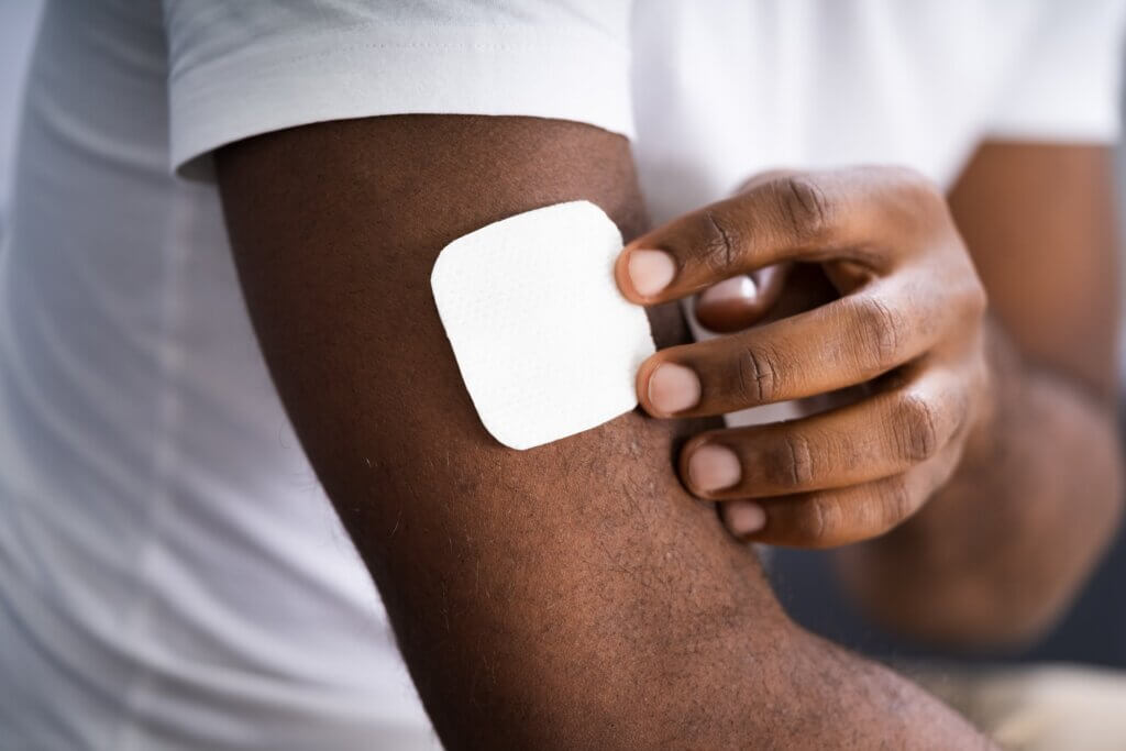 A black man wearing a nicotine patch.