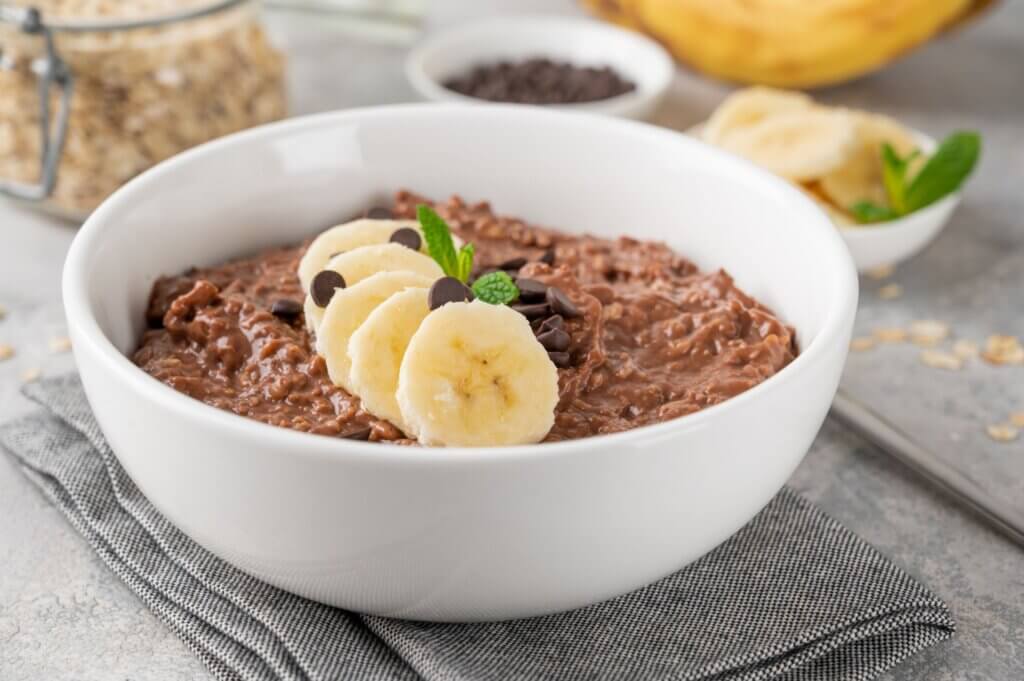 Chocolate oatmeal with banana slices on top.