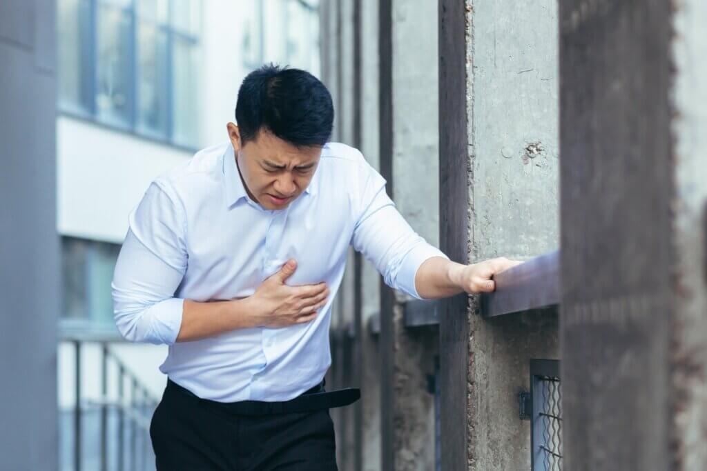An Asian man experiencing chest pain.